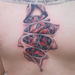 Iron Horse Tattoo Studio - heart tear out tattoo. realistic work.