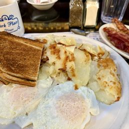Two eggs, over easy, rye toast, potatoes and bacon. Perfection. I love it here Two eggs, over easy, rye toast, potatoes and bacon. Perfection. I love it here