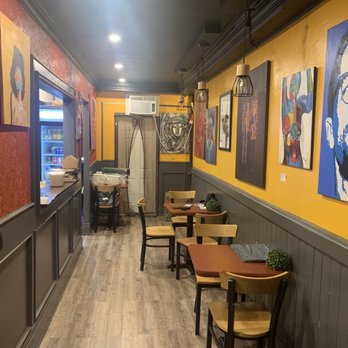 Boukan - a man standing in a restaurant - Burgers Near Me - Toronto, Ontario