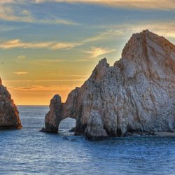 Travel & Cruise Desk - Mexico - The famous Arch of Cabo San Lucas at sunset along the Baja coastline.