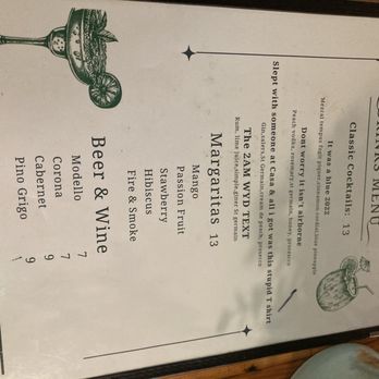 Casa Maya - Menu - A printed drink menu from Casa Maya in Brooklyn, NY, displaying a list of beverages including margaritas, beer, and wine. The menu has a decorative illustration of a cocktail glass with fruit and leaves. It includes sections for drinks and beer & wine, with prices listed. The menu is presented in a vertical format with a simple, elegant design. - Bars Near Me - Brooklyn, New York