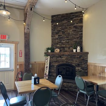Sweet Acres Creamery - tables and chairs in front of a fireplace - Cheese Shops Near Me - Geneva, New York