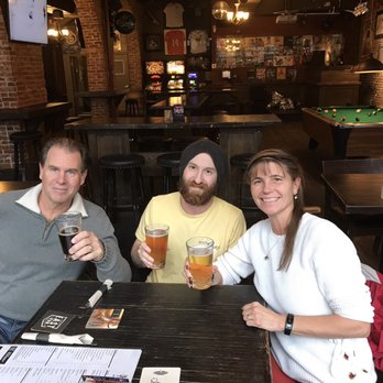 London Pub - three people sitting at a table drinking beer - Pubs Near Me - Vancouver, British Columbia