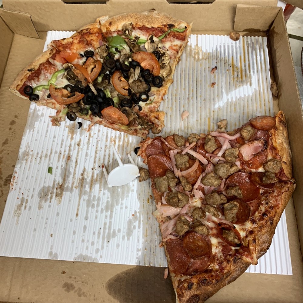 "Giant" Pizza after only 6 slices removed. Half was all meat, missing the linguica and bacon, the other half vegetarian. "Giant" Pizza after only 6 slices removed. Half was all meat, missing the linguica and bacon, the other half vegetarian.