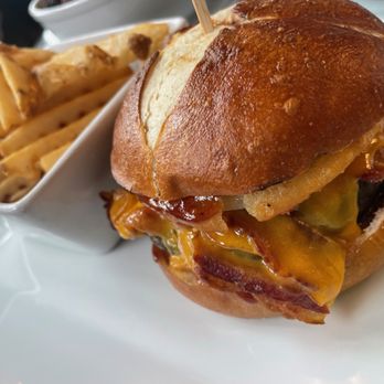 Library Café - Smokehouse Burger: hickory smoked bacon, smoked cheddar, crispy onion rings, sweet baby ray's BBQ sauce, pretzel bun - Cocktail Bars Near Me - Farmingdale, New York Library Café - Smokehouse Burger: hickory smoked bacon, smoked cheddar, crispy onion rings, sweet baby ray's BBQ sauce, pretzel bun - Cocktail Bars Near Me - Farmingdale, New York