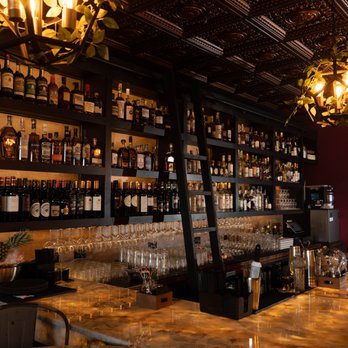Mauve Cocktail Lounge - a bar with many bottles of wine - Cocktail Bars Near Me - Shorewood, Illinois