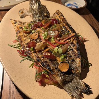 Brasero - Branzino (fried crispy skin with vinaigrette and pickled onions and grapes along with fresh herbs) - Latin American Near Me - Chicago, Illinois