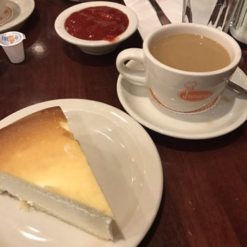 Junior's Restaurant - Slice of classic cheesecake, strawberry topping on the side and a cup of coffee for dessert! - Bakeries Near Me - Brooklyn, New York Junior's Restaurant - Slice of classic cheesecake, strawberry topping on the side and a cup of coffee for dessert! - Bakeries Near Me - Brooklyn, New York