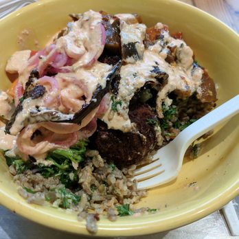 Mezeh - Brown rice bowl with falafel, tabbouleh, eggplant, mixed veggies, pickled onion, harissa sauce. Incredible flavor! - Mediterranean Near Me - Henrico, Virginia