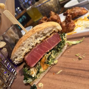 Finney's Crafthouse - Redlands - Ahi sandwhich (soo good) + boneless yuzu buffalo wings behind. - New American Near Me - Redlands, California