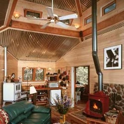 Cabin At Strawberry Hill - Inside Strawberry Cabin, from the bed toward the fireplace and kitchen