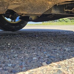 Meineke Car Care Center - The incorrect oil filter that was applied hanging out the bottom of the car.