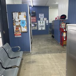 Small seating area with vending machine.