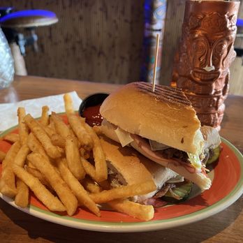 The Lobby Tiki Bar & Grill - Cubano sandwich with Temple of Doom cocktail - Tiki Bars Near Me - Oceanside, California The Lobby Tiki Bar & Grill - Cubano sandwich with Temple of Doom cocktail - Tiki Bars Near Me - Oceanside, California