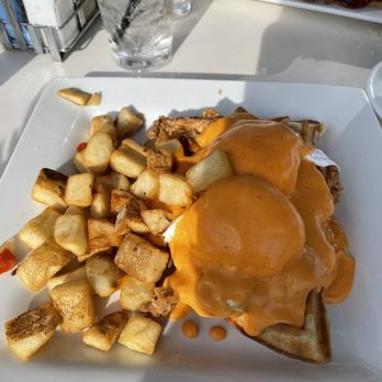 Chez Fabien - Chicken & Waffle Eggs Benedict with Sriracha Hollandaise sauce - French Near Me - Grapevine, Texas