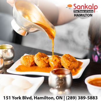 Sankalp Indian Restaurant - a plate of food being drizzled with sauce - Indian Near Me - Hamilton, Ontario Sankalp Indian Restaurant - a plate of food being drizzled with sauce - Indian Near Me - Hamilton, Ontario