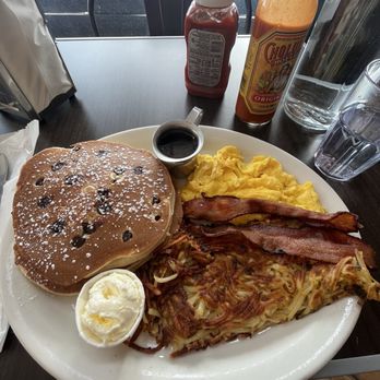 Millie's Cafe - Chocolate chip pancake combo with scrambled eggs, bacon, and hashbrown. - Breakfast & Brunch Near Me - Los Angeles, California