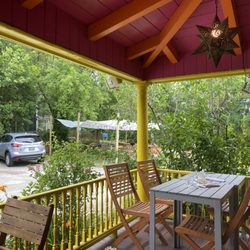 Xicohtencatl - Outdoor dining on a colorful porch with star chandelier