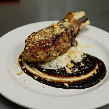 Sofra - Double cut pork chop, Korean BBQ, coconut rice, and crumbled peanut garnish. - Italian Near Me - Bradenton, Florida Sofra - Double cut pork chop, Korean BBQ, coconut rice, and crumbled peanut garnish. - Italian Near Me - Bradenton, Florida