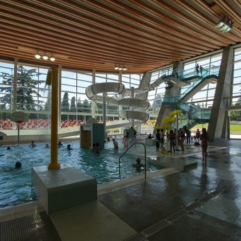 Grandview Heights Aquatic Centre - Kids' area with giant slide on the right and smaller toddler slide on the left.  This is the view from the open locker room. - Swimming Pools Near Me - Surrey, British Columbia