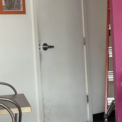 La Taquisa - The filthy bathroom door that looks like it has never seen a wipe down.