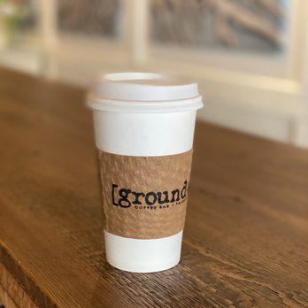 Grounded Coffee Bar - a cup of coffee on a table - Coffee & Tea Near Me - Frankfort, Illinois