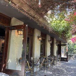 Garden patio space with greenery providing sun cover. Garden patio space with greenery providing sun cover.