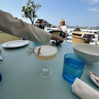 Le Bilboquet - a person serving a drink - French Near Me - Sag Harbor, New York Le Bilboquet - a person serving a drink - French Near Me - Sag Harbor, New York