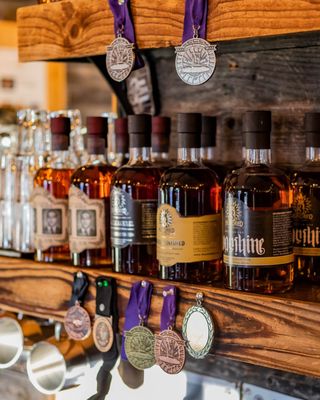 Photo of 3 Hundred Days Distilling - Monument, CO, US. bottles of alcohol on a shelf