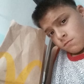 McDonald's - a boy with a bag of food - Coffee & Tea Near Me - Twin Falls, Idaho