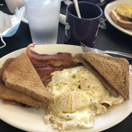Over easy eggs, bacon, toast and hash browns