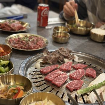 Kim's BBQ - a man sitting at a table with a lot of food - Barbeque Near Me - Rolling Hills Estates, California