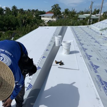 T.Ryan Contracting - Tpo roofing being mechanically attaches with Fluro carbon coated screws and metal plates under the robot welded lap - Roofing Near Me