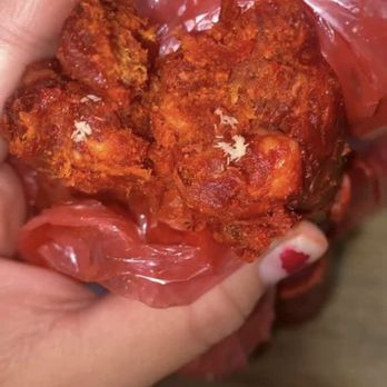 Los Novillos Market - a person holding a bag of fried chicken - Grocery Near Me - Riverside, California