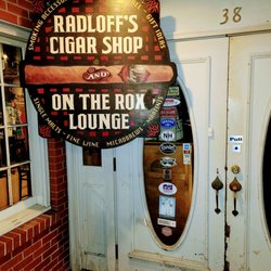 Radloff's Cigar Shop - Beautiful wooden enterance sign in a regal brick building.