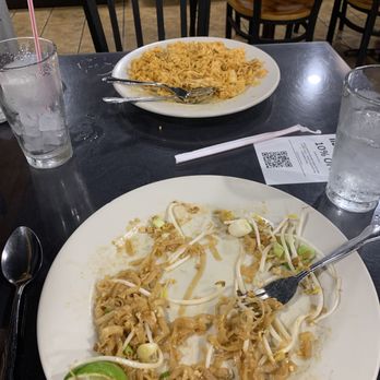 Thai Kitchen - Empty and plate of pad thai and full plate of food sitting across from it. - Thai Near Me - Austin, Texas Thai Kitchen - Empty and plate of pad thai and full plate of food sitting across from it. - Thai Near Me - Austin, Texas
