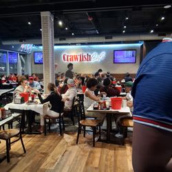 Crawfish Cafe - They recommended  the Chargrilled Oysters and the Crawfish. In this photo there are lots of happy people eating .