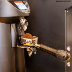 The Coffee Gin - Prepping a portafilter with espresso to make a specialty coffee drink.
