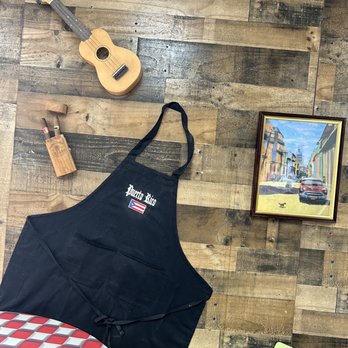 Julios Empanadas - a guitar, a guitar, and a black apron - Latin American Near Me - Gulfport, Florida
