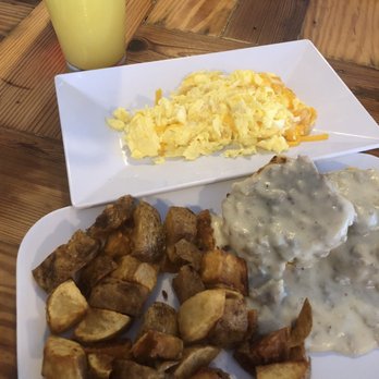 The Blue Hen Cafe - Half biscuits n gravy with home cut potatoes. YUM!!!! (I got the egg from the bf's corned beef hash). Had plated separately. & Mimosa! - Southern Near Me - Saint Augustine, Florida