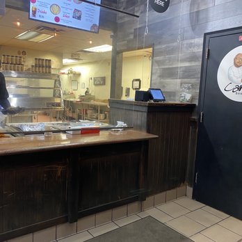 Carmi Express - a man preparing food in a restaurant - Soul Food Near Me - Pittsburgh, Pennsylvania