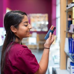 Face To Face Spa - Esthetician examining the beauty products.