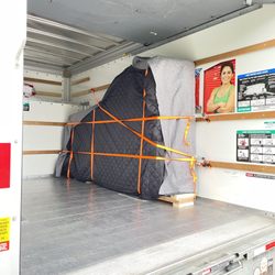 Precision Piano - Re-homing a 9' concert grand piano. Safely loaded, padded, and strapped securely.