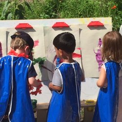 Country Kids Schoolhouse - Painting outside by the Zinnia & Sunflower Garden
