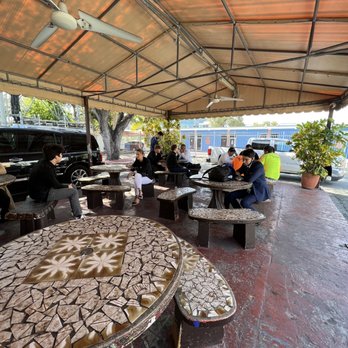 Palace Cafe & Dairy - a group of people sitting at a picnic table - Ice Cream & Frozen Yogurt Near Me - Miami, Florida