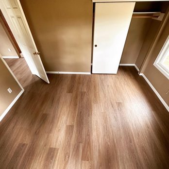 Whisler Renovations - an empty room with wood floors - Flooring Near Me Whisler Renovations - an empty room with wood floors - Flooring Near Me