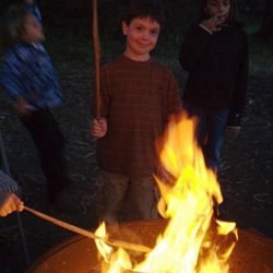 River Rock Vacation Cottage - A young friend enjoys a camfire on the beach