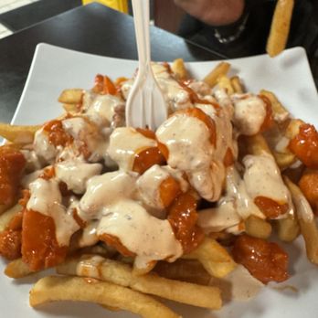 Wings Empire - a plate of fries with sauce and a fork - Chicken Wings Near Me - La Mesa, California Wings Empire - a plate of fries with sauce and a fork - Chicken Wings Near Me - La Mesa, California