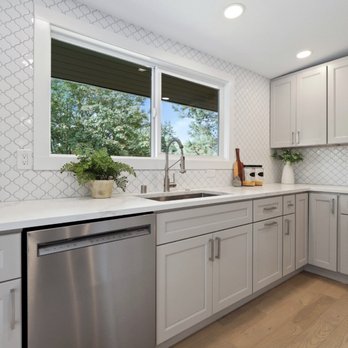 Patrick's Flooring - a kitchen with white cabinets and a stainless steel dishwasher - Flooring Near Me - Mukilteo, Washington Patrick's Flooring - a kitchen with white cabinets and a stainless steel dishwasher - Flooring Near Me - Mukilteo, Washington