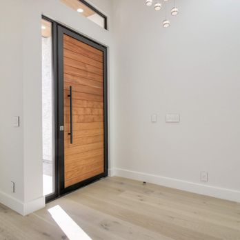 Seyed Construction - a modern entryway with a wooden door - General Contractors Near Me